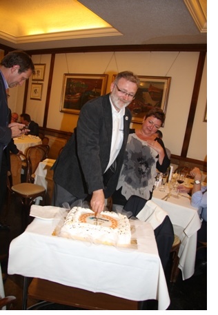 Thomas Juchum cuts the cake in celebration of ten years of EUROMOVERS International