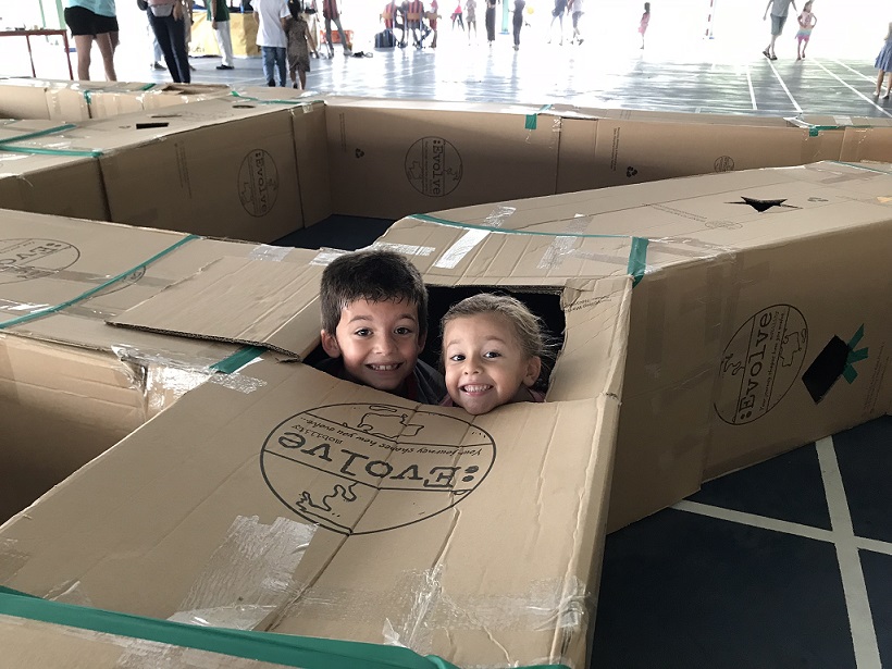 School children enjoying the labyrinth maze constructed from recycled cartons