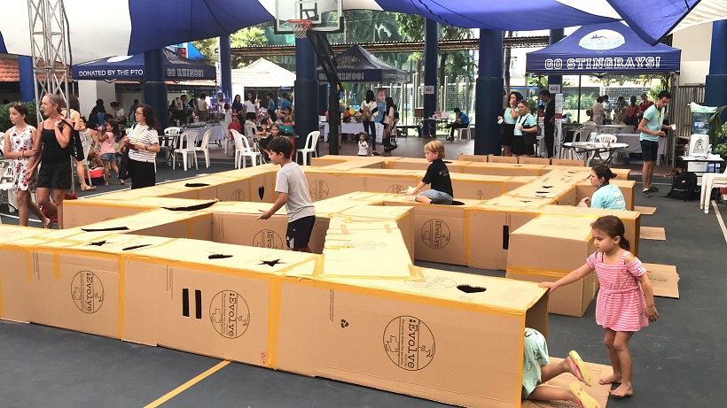 School children in the labyrinth maze constructed from recycled cartons