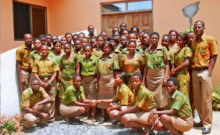 Students pose in front of the school