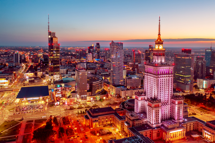 Warsaw city centre at night, with the Palace of Science and Culture in the foreground