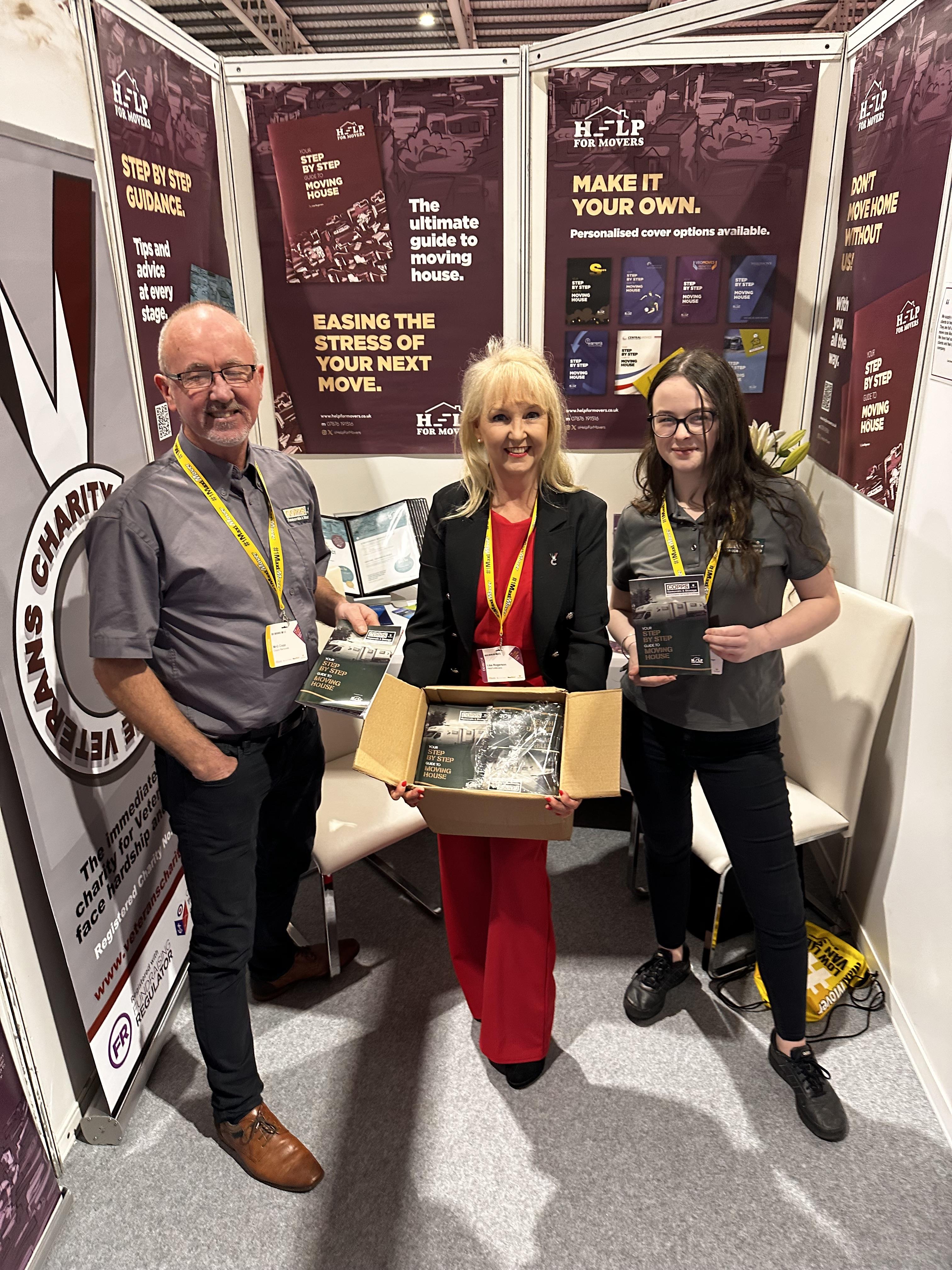 Lisa hands over a new batch of booklets to Copps Removals